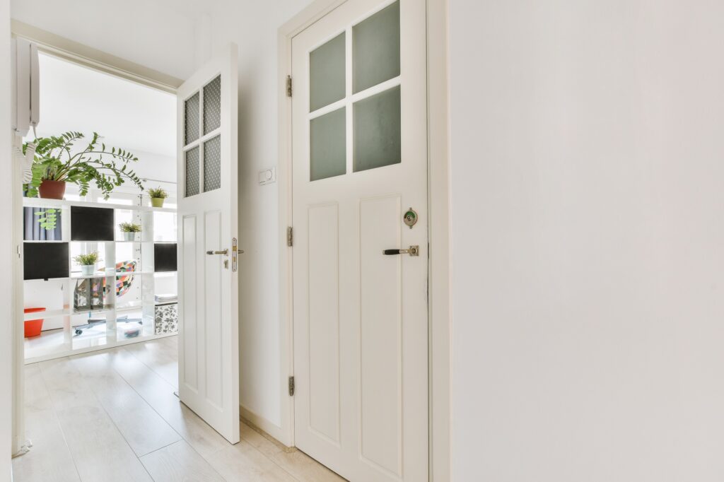 Narrow corridor with doors and lamp